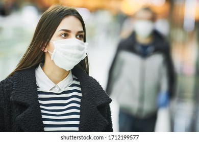 woman with protective face mask at public place. corona virus outbreak - Powered by Shutterstock