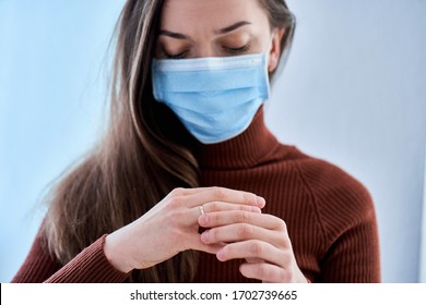 Woman In Protective Mask Remove Ring From Finger. Break Up Relationship And Divorce After Living Together During Quarantine And Isolation Due To Coronavirus Covid Epidemic. Divorce Concept