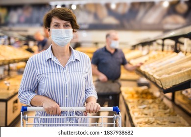 Woman In Protective Mask With Shopping Cart In Grocery Hypermarket