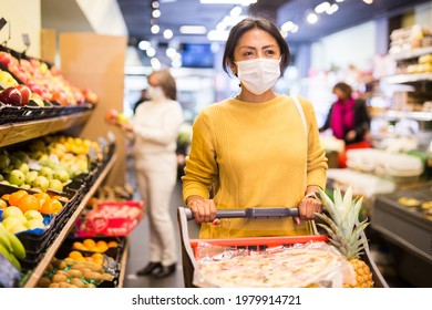 Woman In Protective Mask Shopping At Grocery Store