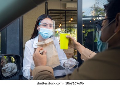 Woman In Protective Mask Taking Coffee At Drive Thru During Coronavirus Outbreak, Concept For New Normal Between Covid 19 Pestilence.