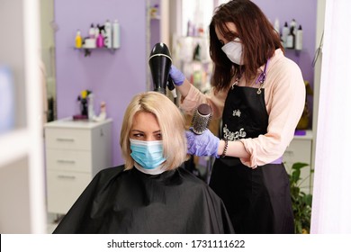 Woman in protective medical mask and hairdresser. Hairdressing salon opened! Covid-19, coronavirus . Quarantine period in city is over! Small business and covid-19, coronavirus