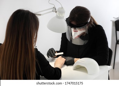 Woman In Protective Medical Mask And Manicurist. Beauty Salons, Manicure, Nail Care Opened! Covid-19, Coronavirus .