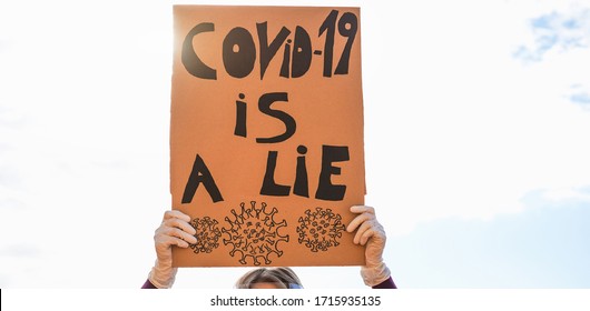 Woman protest for Coronavirus economic crisis outdoor - Covid-19 excuses and global disaster concept - Focus on banner - Powered by Shutterstock