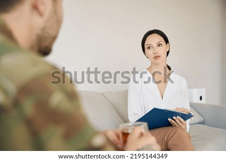 Woman psychologist is communicates with soldier patient