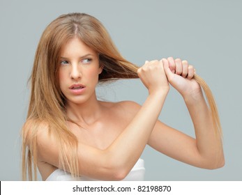 Woman Pulling Damaged Hair With Both Hands