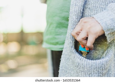 Woman pulling keys out of coat's pocket - Apartment owner selling or renting home - Landlord renting residence