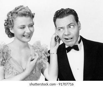 Woman pulling a man's ear