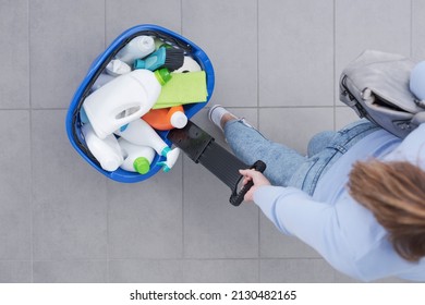 Woman Pulling A Shopping Basket Full Of Cleaning Products At The Store, Top View