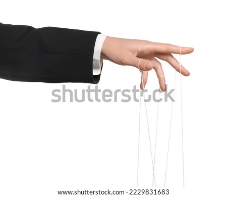 Woman pulling strings of puppet on white background, closeup