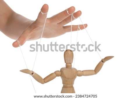 Woman pulling strings of puppet on white background, closeup