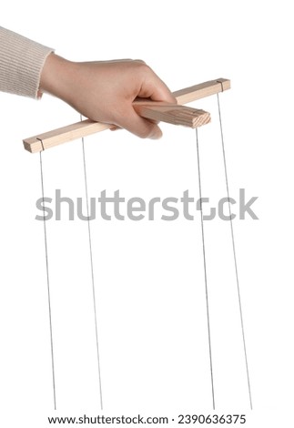Woman pulling strings of puppet on white background, closeup