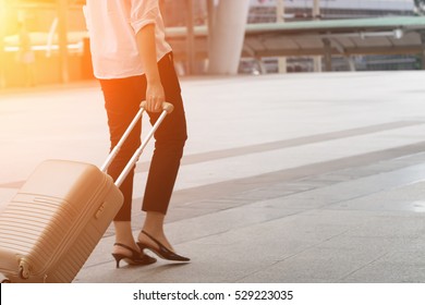 A woman are  pulling suitcase in the city