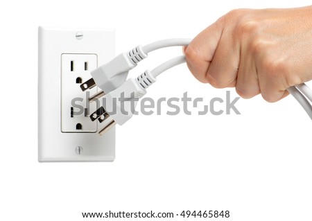 Woman pulling yanking unplugging electrical plugs cords from household wall power outlet isolated on white background
