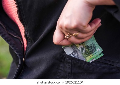 Woman Pulls Australian Dollar Paper Money Out Of Her Pocket