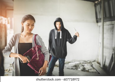 Woman Pulls A Gun From Her Swanky Purse While The Thief Stood In The Back. Conceal Carry Weapon For Protection Themselves Concept. Selective Focus.