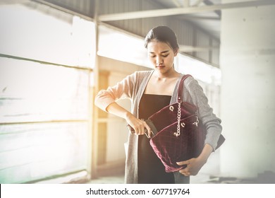 Woman Pulls A Gun From Her Swanky Purse. Conceal Carry Weapon For Protection Themselves Concept. Selective Focus To Gun.