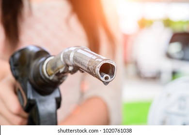 Woman Pumping Gasoline Fuel In Car At Gas Station.