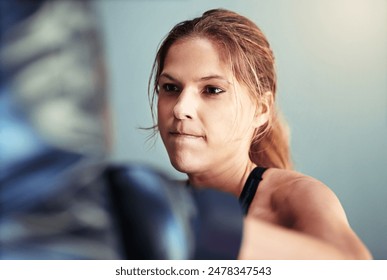 Woman, punching bag and boxer in gym with power, mma and gloves for competition, sports and training. Person, athlete and ready for martial arts, exercise and workout for combat, fight and contest - Powered by Shutterstock