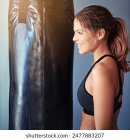 Woman, punching bag and smile in gym for training, mma and excited for competition, sports and fitness. Person, happy and ready for martial arts, workout and exercise for combat, fight or contest - Powered by Shutterstock