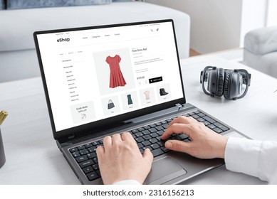 Woman purchasing a stunning red dress online with laptop computer. Modern ecommerce web page interface - Shutterstock ID 2316156213