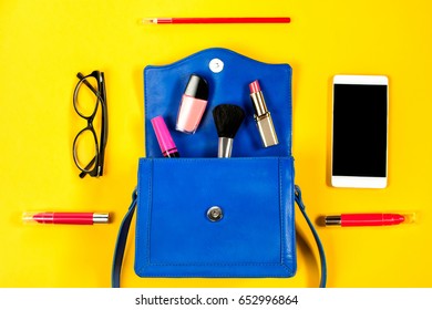 Woman Purse, Beauty Products, Smartphone, Glasses On A Bright Yellow Background, Top View