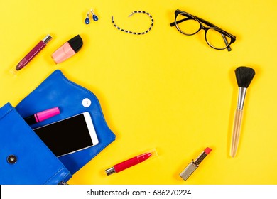 Woman Purse, Beauty Products, Smartphone, Glasses On A Bright Yellow Background, Top View