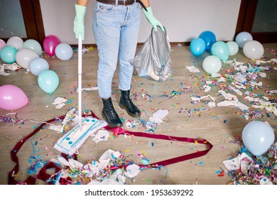 Woman With Pushbroom Cleaning Mess Of Floor In Room After Party Confetti, Morning After Party Celebration, Housework, Cleaning Service