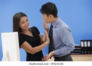 Woman Pushing Away Businessman