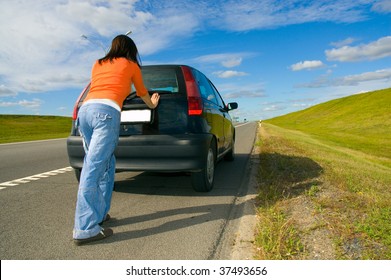 Woman Pushing A Car