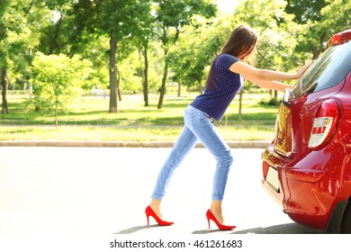 Woman Pushing Red Car