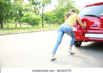 Woman Pushing Red Car