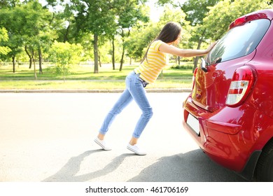 Woman Pushing Red Car