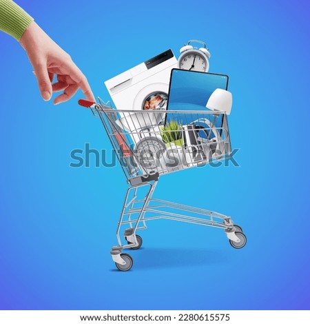 Woman pushing a small shopping cart full of household goods, appliances and electronics