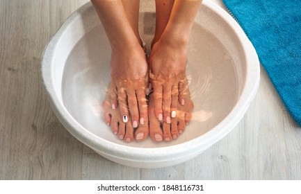 Woman Put Hands And Feet In Bath With Hot Water And Baking Soda At Home. Homemade Bath Soak For Dry Feet Skin