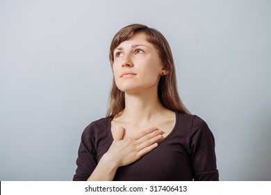 The Woman Put Her Hands On His Chest. Gray Background