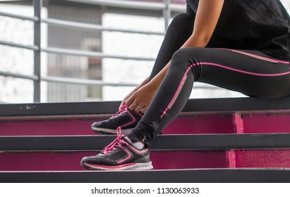 Woman put the worm pant Rope tie shoe run in  stairs gym. Exercise concept - Powered by Shutterstock