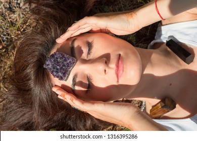 Woman Puts Amethyst Stone On Her Forehead