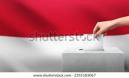 Woman puts ballot paper in voting box on Indonesia flag background. Election concept.