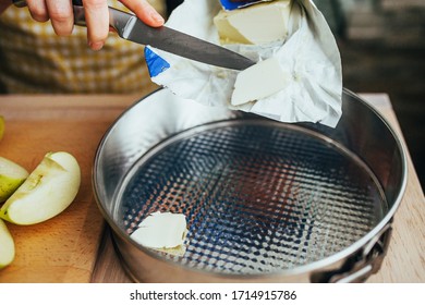 Woman Puts Butter In A Detachable Baking Dish - Home Baking