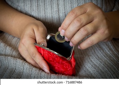 A Woman Puts A Coin In An Empty Purse. Red Coin Purse.