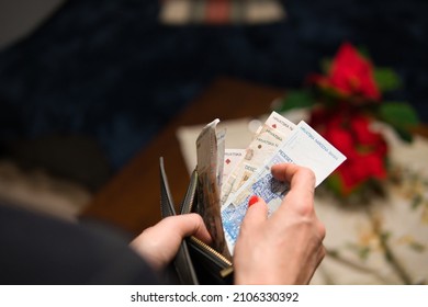 a woman puts Croatian Kuna in her wallet. The woman is holding Croatian money. Concept showing the Croatian economy.