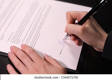 Woman Puts A Fake Signature On The Fake Contract. No Faces, No Confidential Information