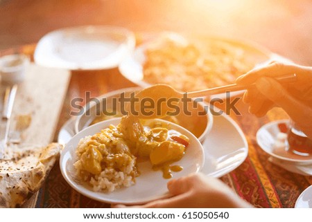 Woman puts food on a plate, sunny