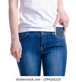 Woman puts mobile phone in jeans pocket on white background. Isolation