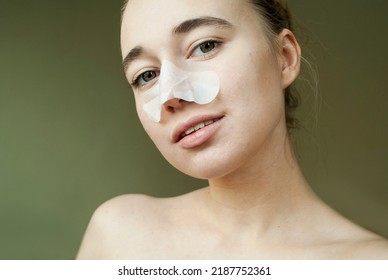 Woman Puts On Nose Cleansing Strips, Moisturizing Strips, Blackhead Mask, Gently Looks At The Camera. Spa, Skin Care, Natural Beauty Concept.