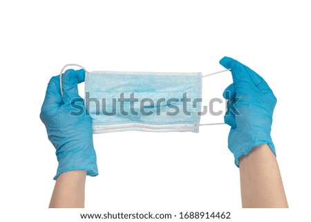 Woman puts on protective mask with blue rubber gloves. Isolated on white.