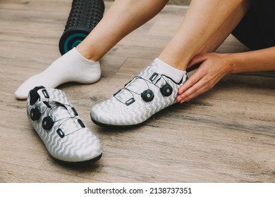 woman puts on shoes for cycling. bicycle shoes - Powered by Shutterstock