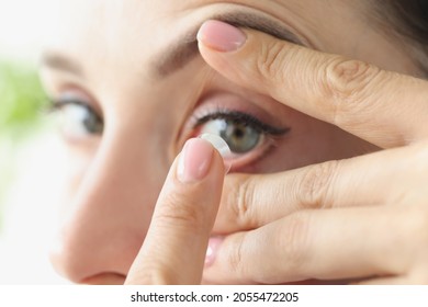 Woman Puts On Soft Contact Lens Over Eyes Closeup