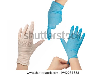 Woman puts on white rubber gloves. Isolated on white.